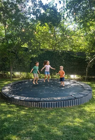 a view of backyard with swimming pool and outdoor seating