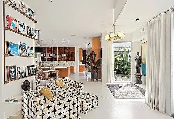 a living room with a couch and a dining table
