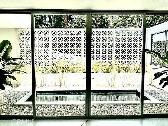 a view of a chairs and table in the patio