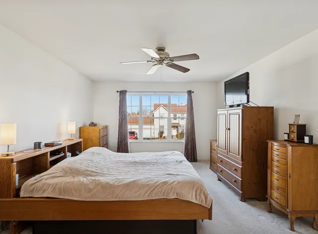 a bedroom with a bed and a television