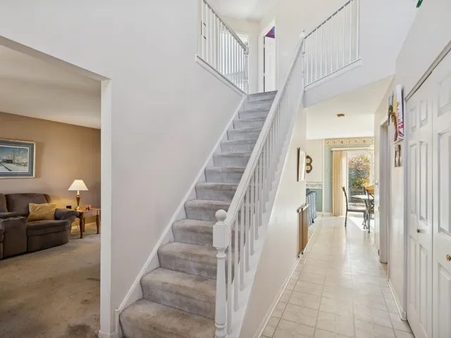 a dining room with furniture a chandelier and window