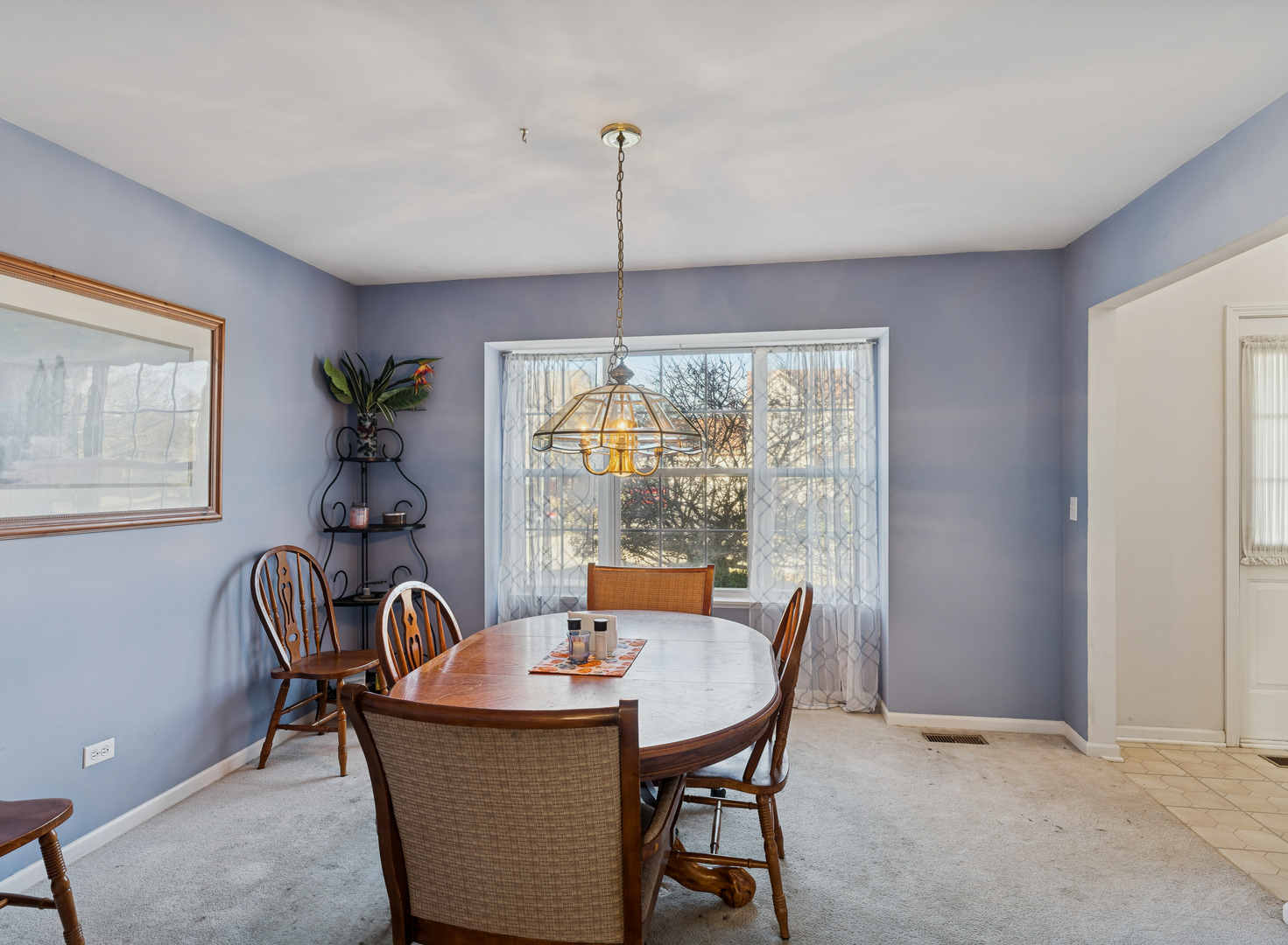 885 Charlton Road Lake Villa, IL 60046 - Photo 4 of 31 a dining room with furniture a chandelier and window