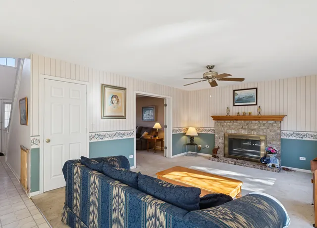 a kitchen with a sink a stove a refrigerator and white cabinets