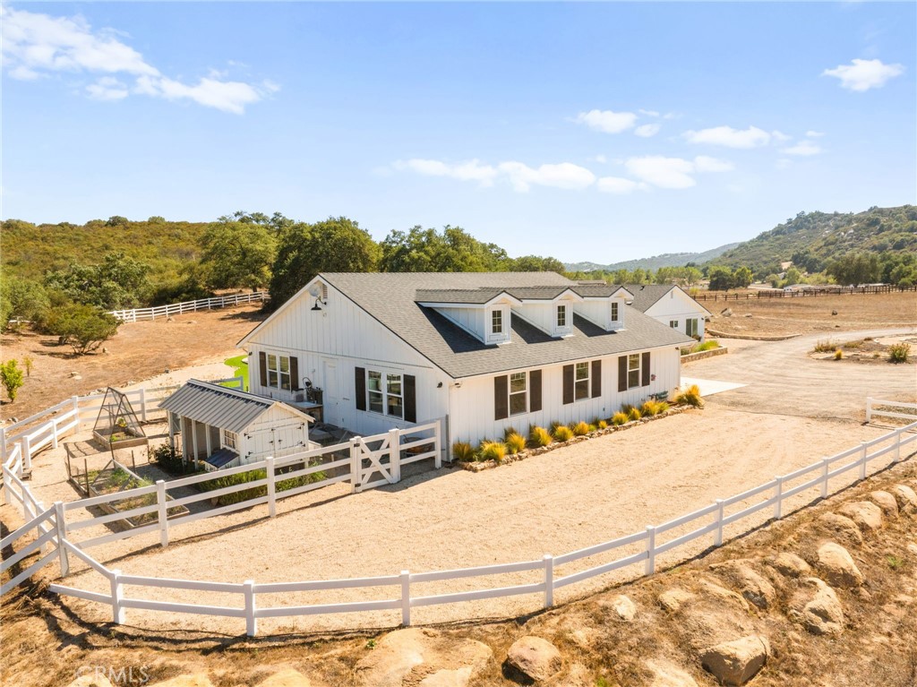 a view of a white house with a yard