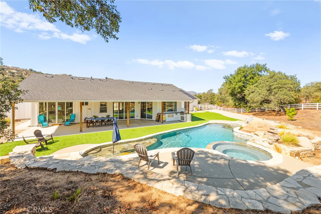 41260 De Anna Ranch Road Murrieta, CA 92562 - Photo 14 of 57 a view of an house with swimming pool and yard