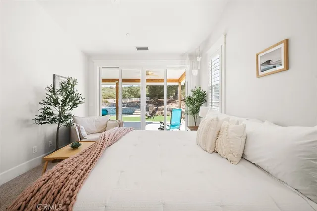 a living room with furniture and large windows