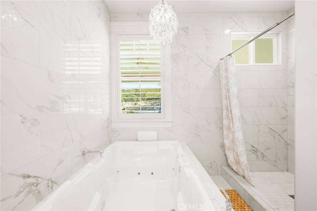 41260 De Anna Ranch Road Murrieta, CA 92562 - Photo 18 of 57 a bathroom with a bathtub and shower