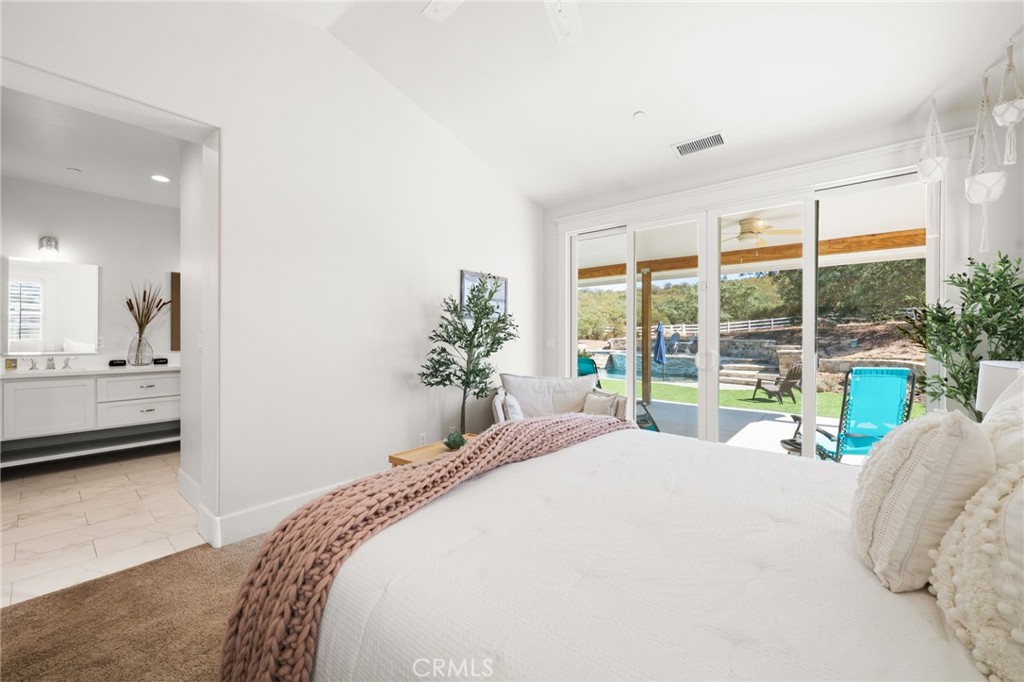 41260 De Anna Ranch Road Murrieta, CA 92562 - Photo 19 of 57 a bedroom with a bed and large windows