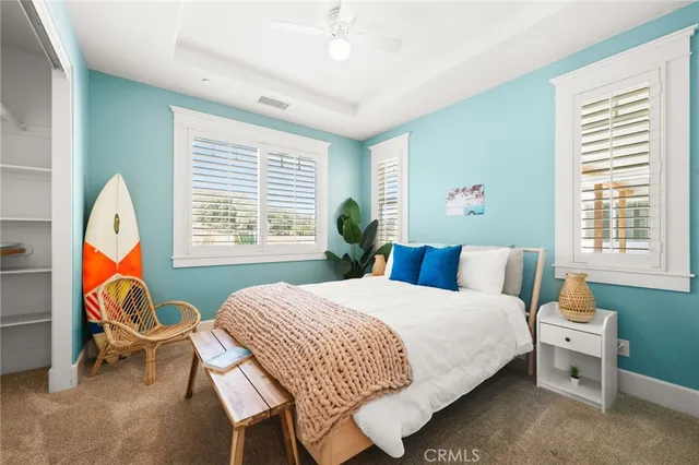 a bedroom with a bed a table and a chandelier