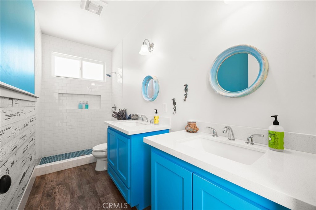 41260 De Anna Ranch Road Murrieta, CA 92562 - Photo 21 of 57 a bathroom with a granite countertop sink a toilet and a mirror