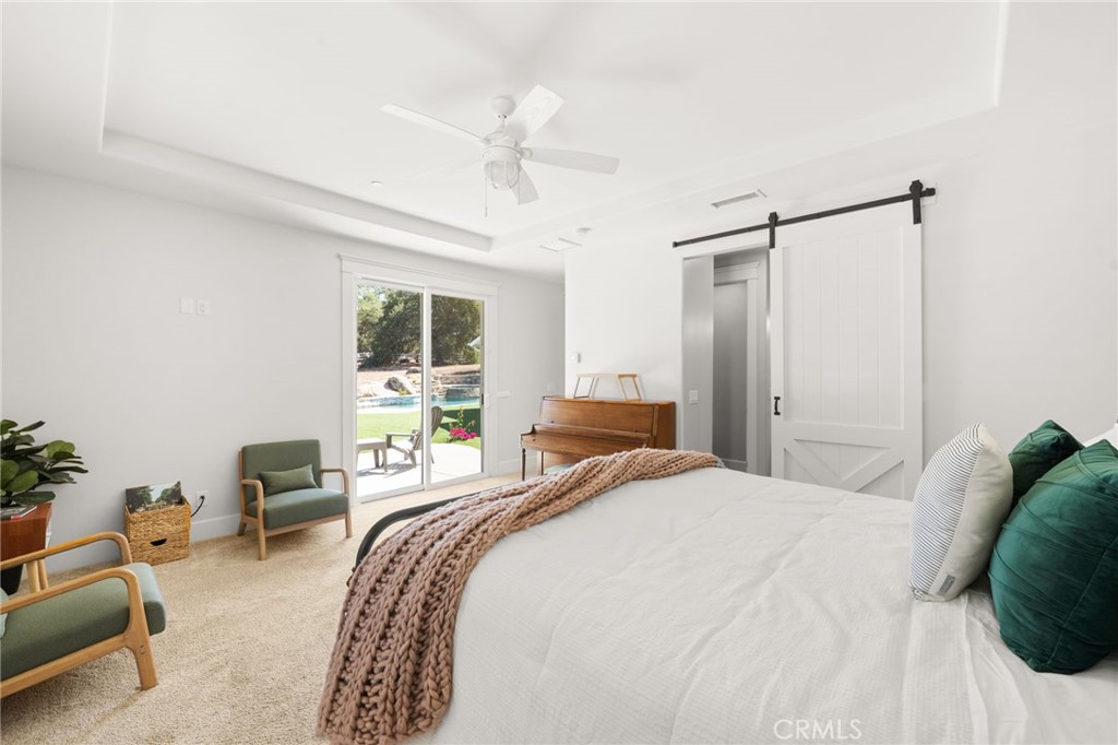 41260 De Anna Ranch Road Murrieta, CA 92562 - Photo 26 of 57 a bedroom with a bed and a chandelier