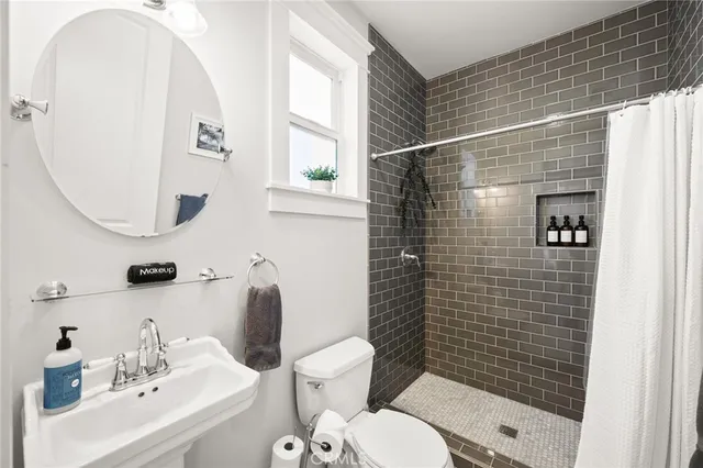 a bathroom with a toilet and a shower