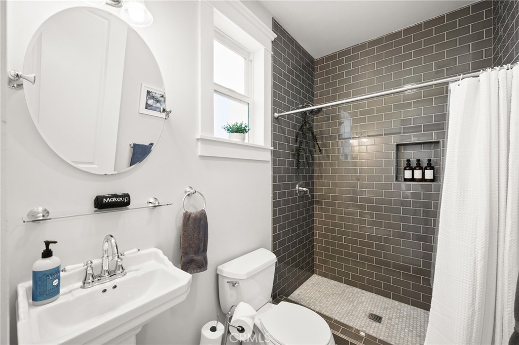 41260 De Anna Ranch Road Murrieta, CA 92562 - Photo 30 of 57 a bathroom with a sink mirror toilet and shower