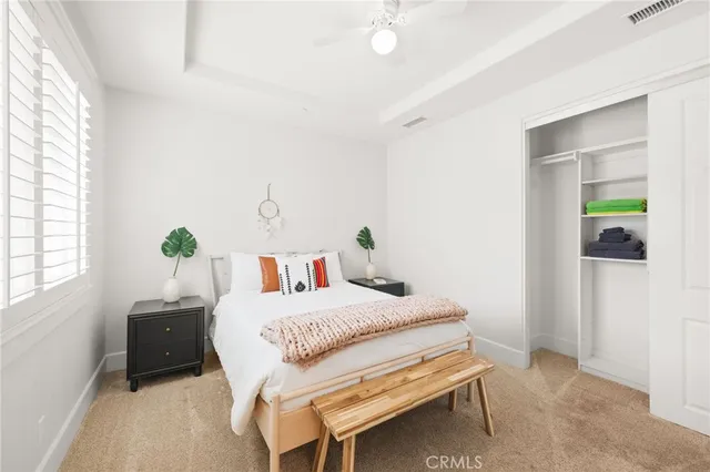 a hallway with wooden floor and windows