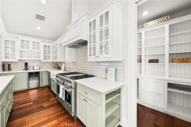 a kitchen with a stove top oven sink and cabinets