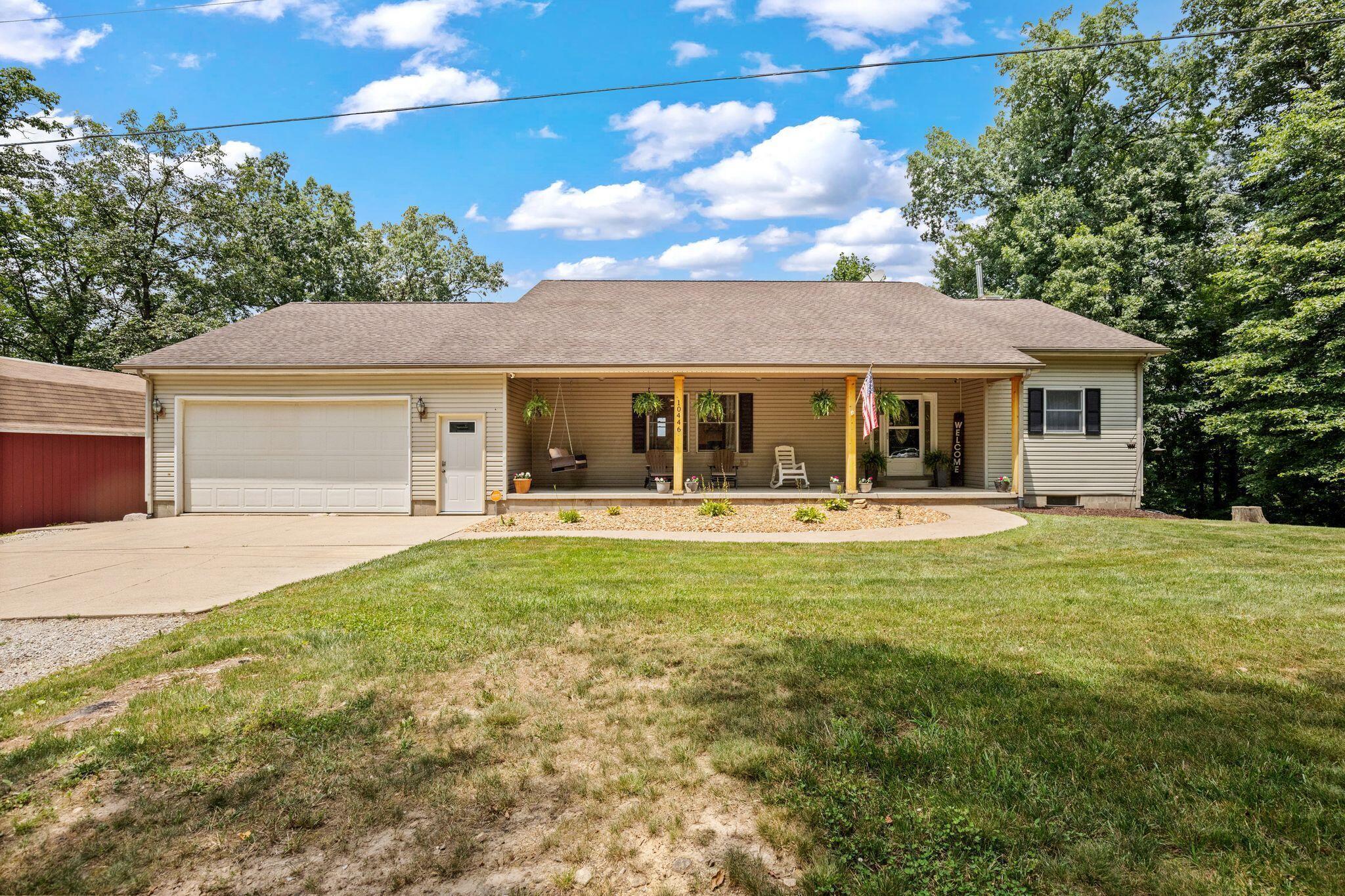 10446 Rich Hollow Road Southwest Lancaster, OH 43130 - Photo 68 of 83 Ranch-style residence featuring a covered front porch with natural wood pillars, light-colored siding, and a two-car attached garage