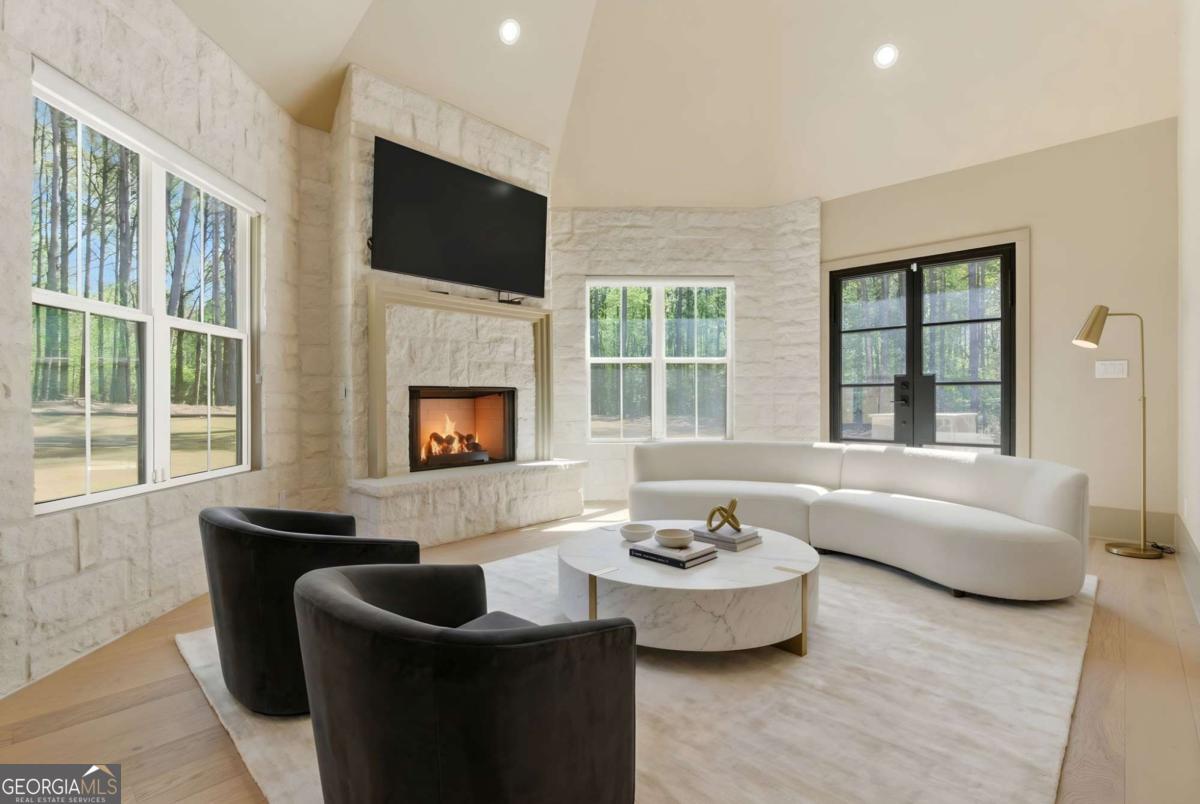 1315 Sandy Creek Road Tyrone, GA 30290 - Photo 57 of 100 a living room with fireplace furniture and a flat screen tv