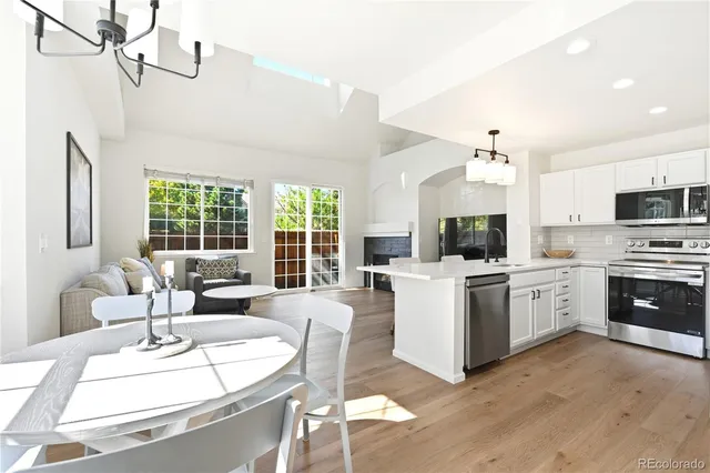 a large white kitchen with a large window