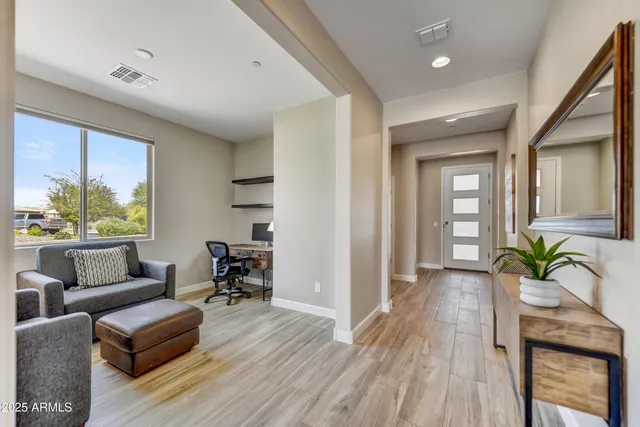 a living room with furniture and a potted plant