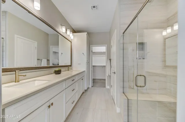 a spacious bathroom with a double vanity sink mirror double and shower
