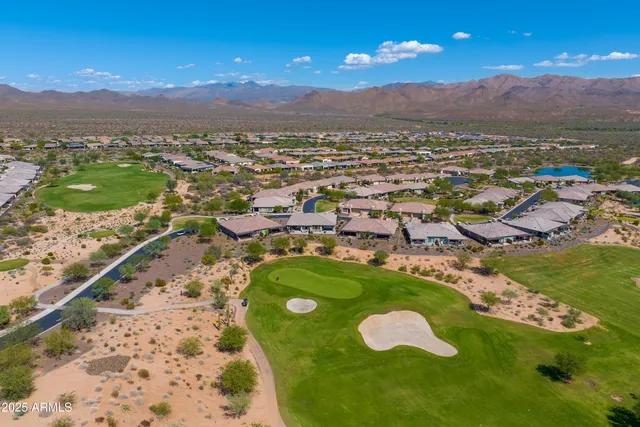 an aerial view of residential houses with outdoor space and ocean view