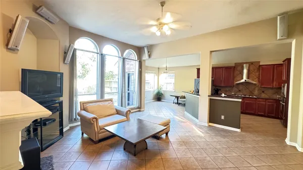 a living room with furniture a dining table and a piano table