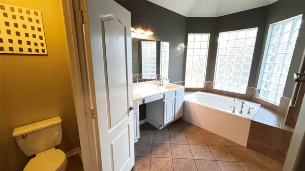 a bathroom with a tub toilet and sink