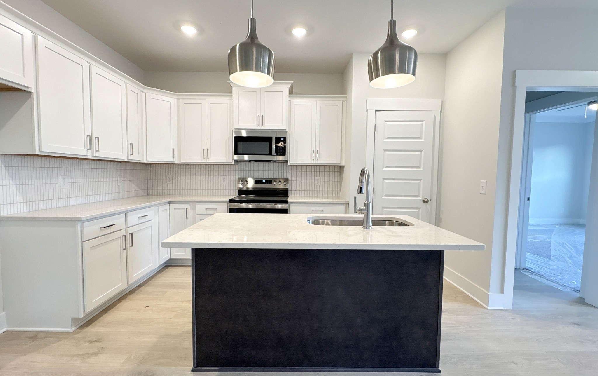 314 Booker Drive Gallatin, TN 37066 - Photo 12 of 30 a kitchen with stainless steel appliances kitchen island granite countertop a sink a stove and cabinets