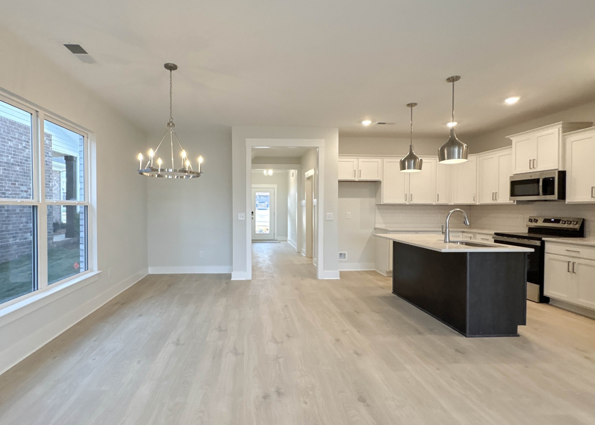 314 Booker Drive Gallatin, TN 37066 - Photo 13 of 30 a large kitchen with kitchen island a sink stainless steel appliances and cabinets