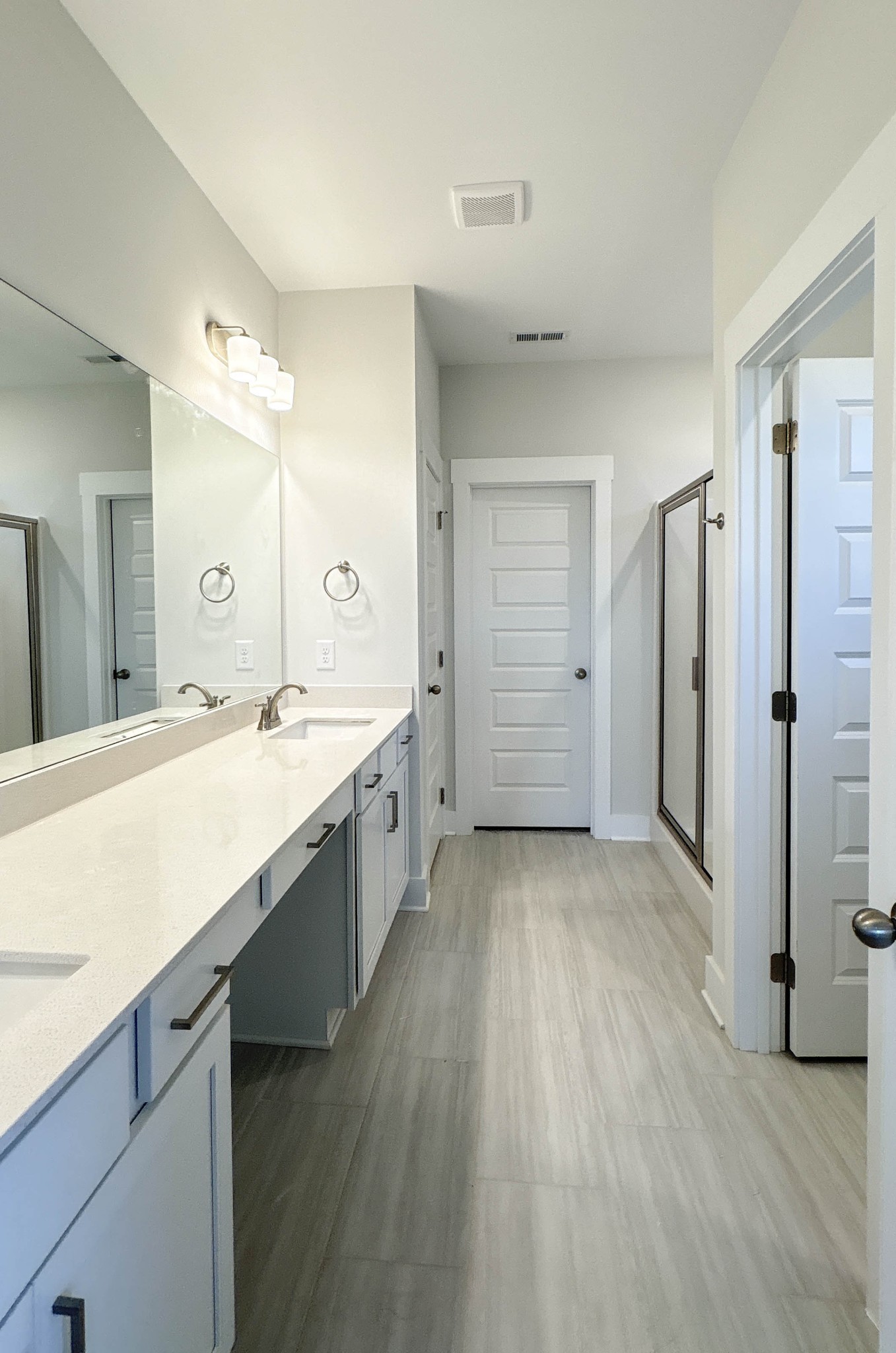 314 Booker Drive Gallatin, TN 37066 - Photo 17 of 30 a large bathroom with a granite countertop double vanity sink a mirror and a shower