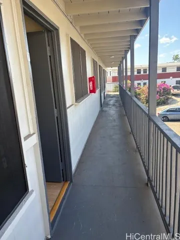 an empty room with wooden floor and mirror