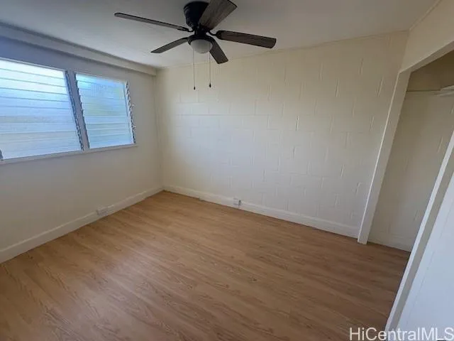 a kitchen with a sink a refrigerator and wooden floor