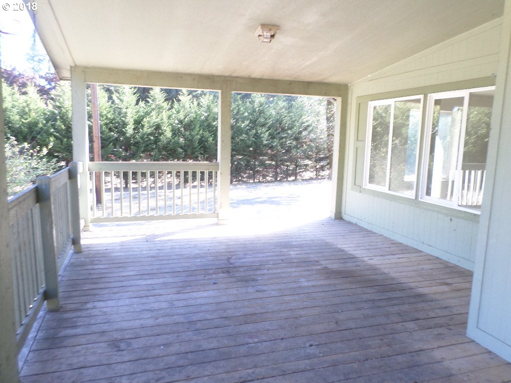 15063 South Hattan Road Oregon City, OR 97045 - Photo 2 of 25 a view of an empty room with wooden floor and a large window