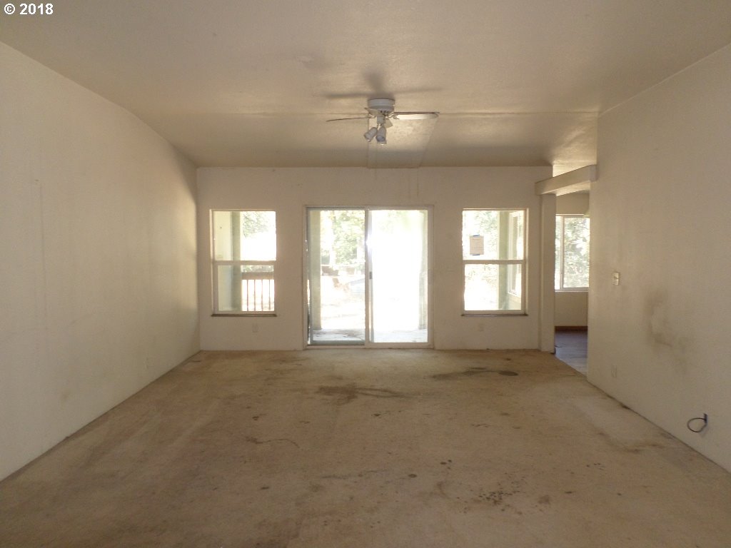 15063 South Hattan Road Oregon City, OR 97045 - Photo 7 of 25 a view of an empty room with a window