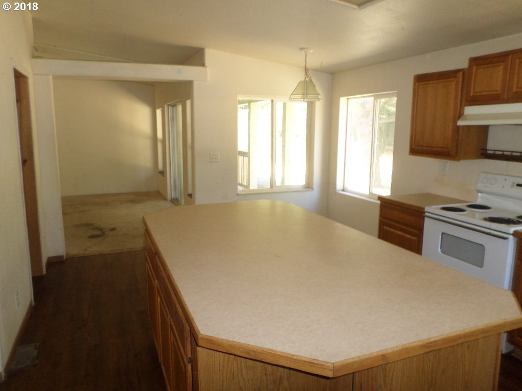 15063 South Hattan Road Oregon City, OR 97045 - Photo 10 of 25 a large white kitchen with a stove a sink and a refrigerator