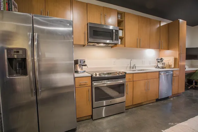 a kitchen with a sink stove and refrigerator