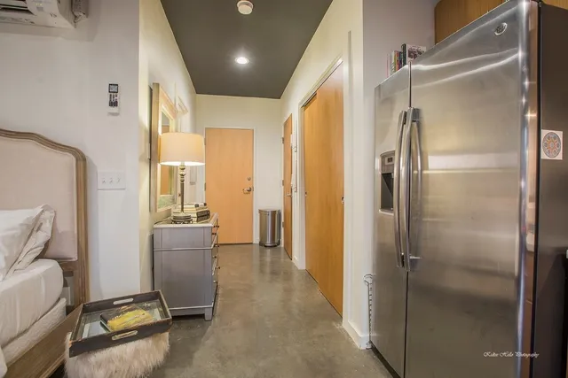 a room with a refrigerator and windows