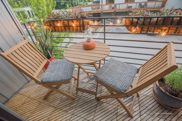 a view of a balcony with wooden floor