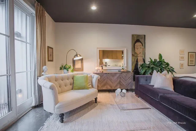 a living room with furniture and a potted plant