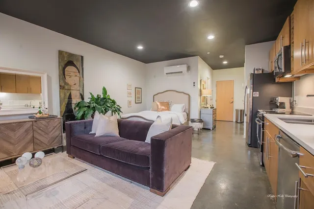 a living room with furniture fireplace and a large window