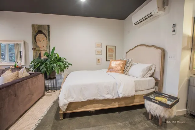 a bedroom with bed and a couch