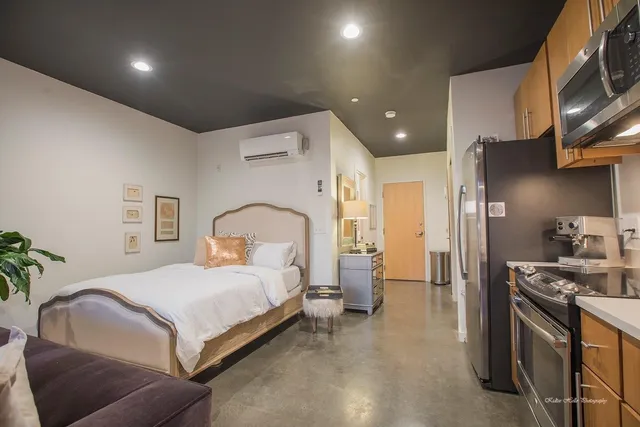 a spacious bedroom with a bed and a couch