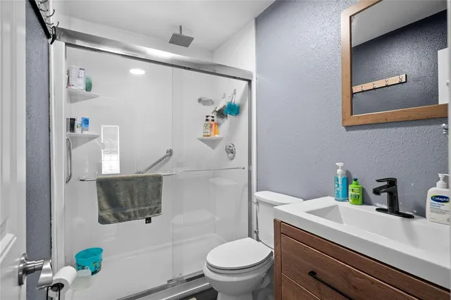a bathroom with a sink a toilet and shower curtain