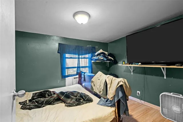 a bedroom with a bed and a chair