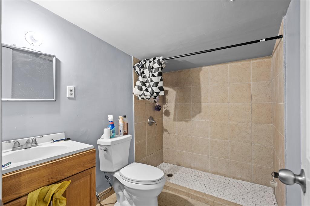 4115 Peachtree Road Balch Springs, TX 75180 - Photo 21 of 24 a bathroom with a sink toilet and shower