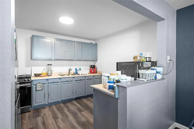 a room with cabinets a sink and appliances