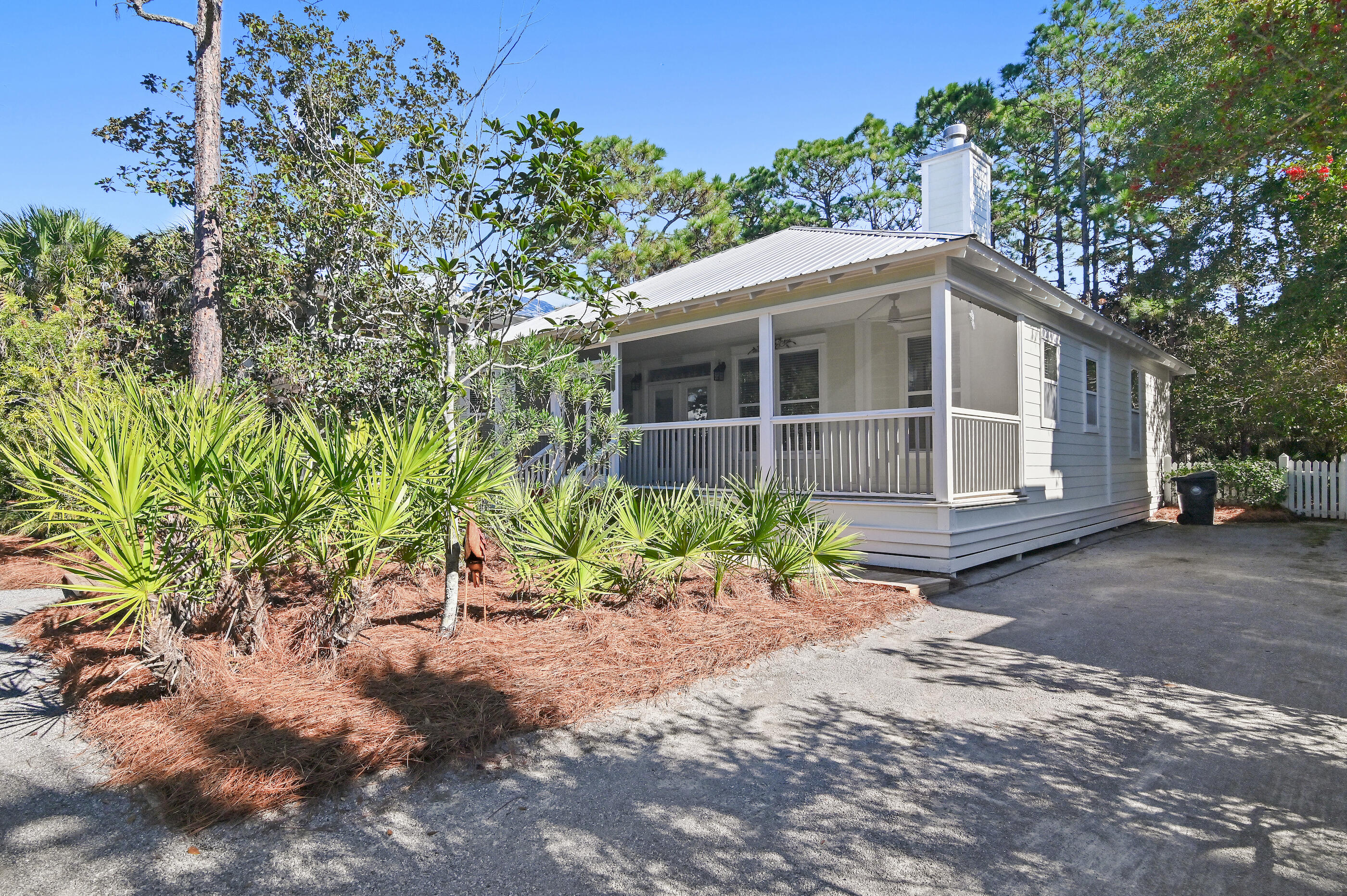 158 Cullman Avenue Santa Rosa Beach, FL 32459 - Photo 1 of 47 a front view of a house with a yard and potted plants