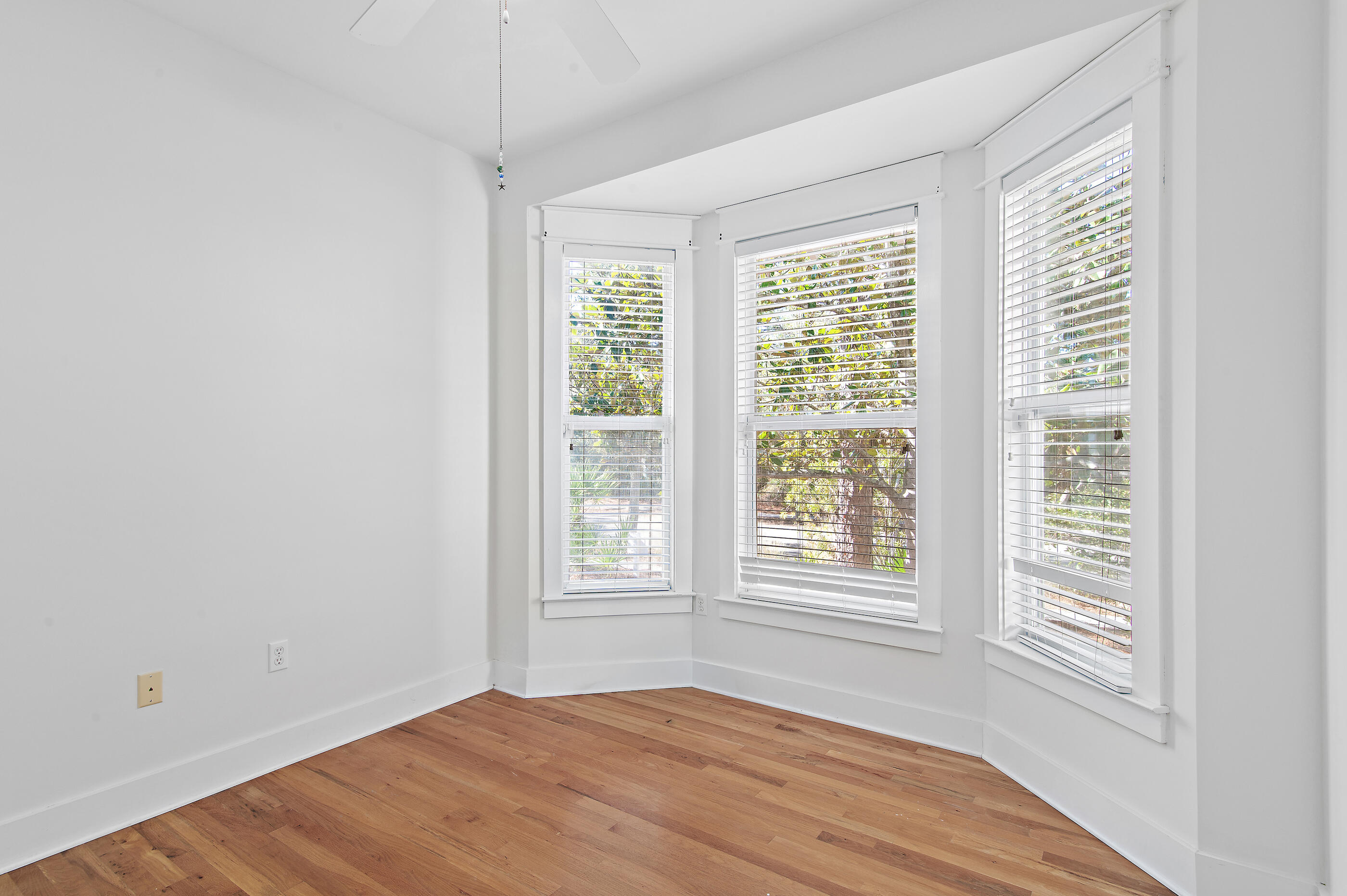 158 Cullman Avenue Santa Rosa Beach, FL 32459 - Photo 12 of 47 a view of an empty room with wooden floor and a window