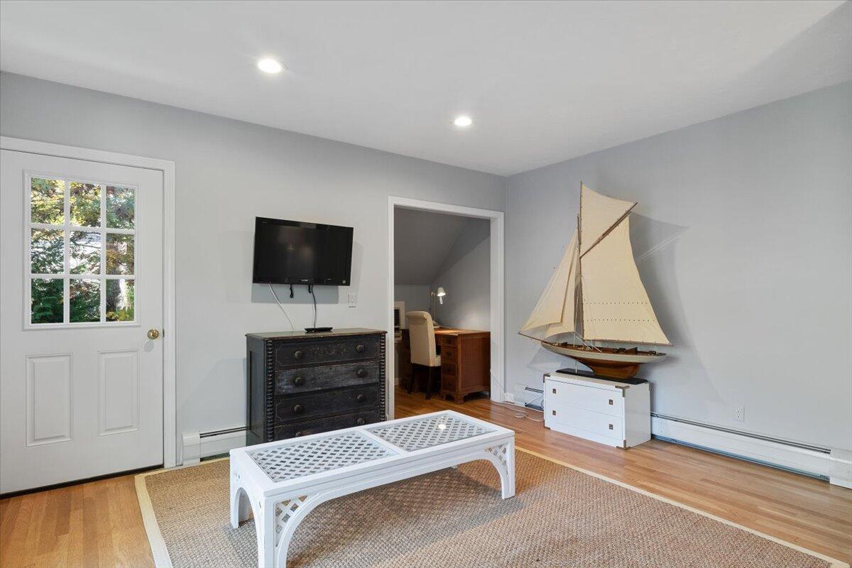 102 Gorham Road Harwich Port, MA 02646 - Photo 50 of 64 a living room with furniture a flat screen tv and a fireplace