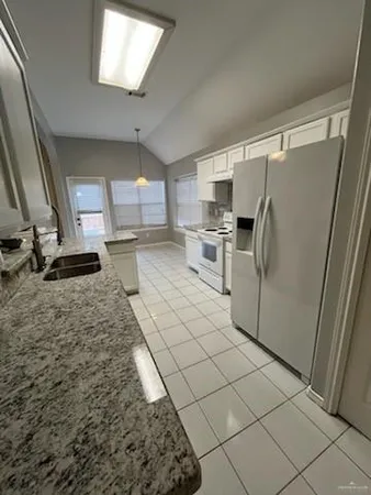 a kitchen with refrigerator and window